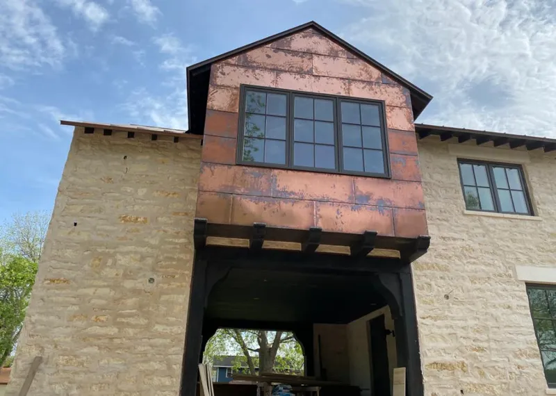 Copper metal panel facade on a stone building for Metal Roof Coating in Ogden